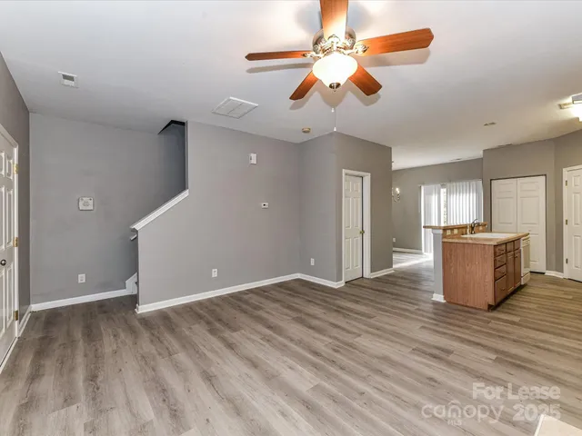 a view of a kitchen with a sink and a chandelier fan