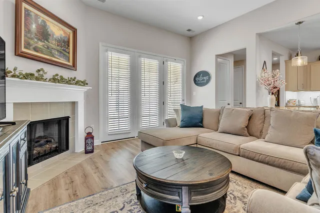 a living room with furniture and a fireplace