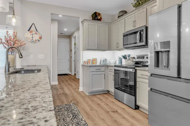 a kitchen with a sink stove and refrigerator