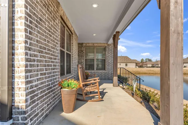 a dining room with furniture and a potted plant