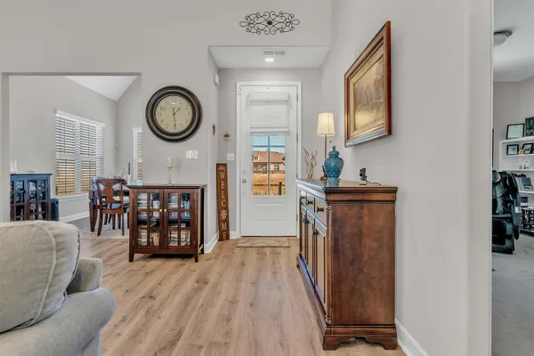 a view of an entryway with wooden floor
