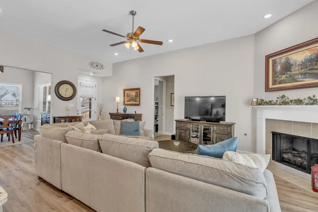 a living room with furniture a fireplace and a flat screen tv