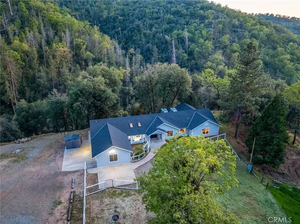 an aerial view of a house with yard and outdoor seating