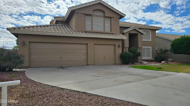 a view of a house with a yard and garage