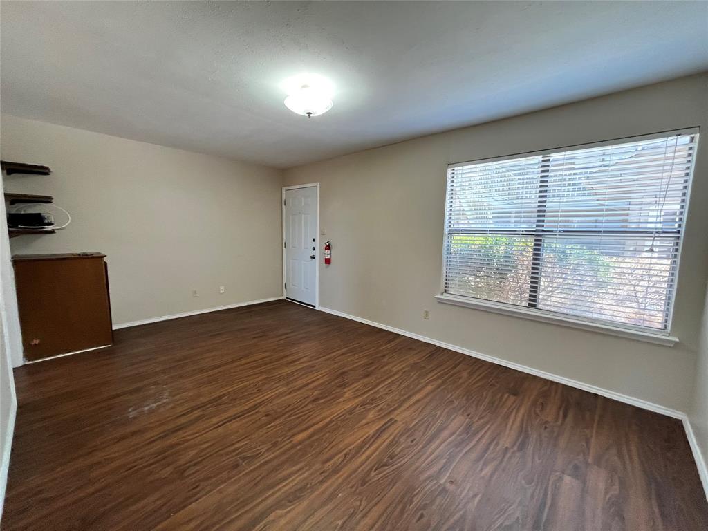 2526 West Prairie Street, Unit 108 Denton, TX 76201 - Photo 5 of 12 The living room is included with cabinet space and pre-existing shelving.