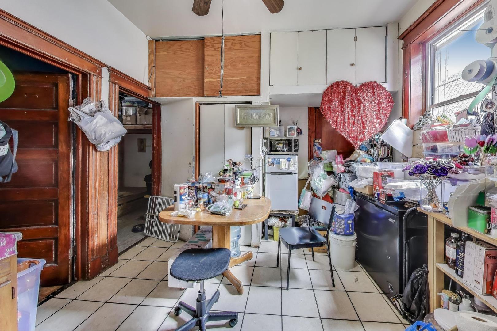 2625 South Central Park Avenue Chicago, IL 60623 - Photo 12 of 36 a room filled with furniture and a lamp