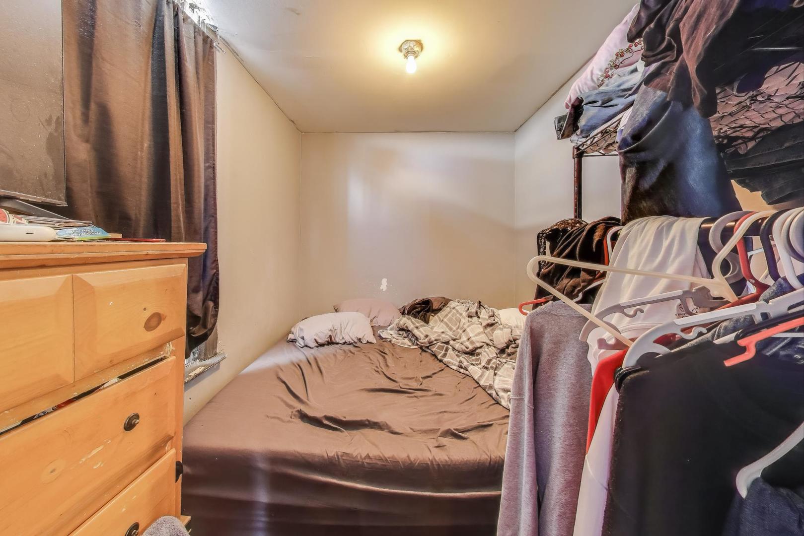 2625 South Central Park Avenue Chicago, IL 60623 - Photo 17 of 36 a view of walk in closet with clothes and shoes