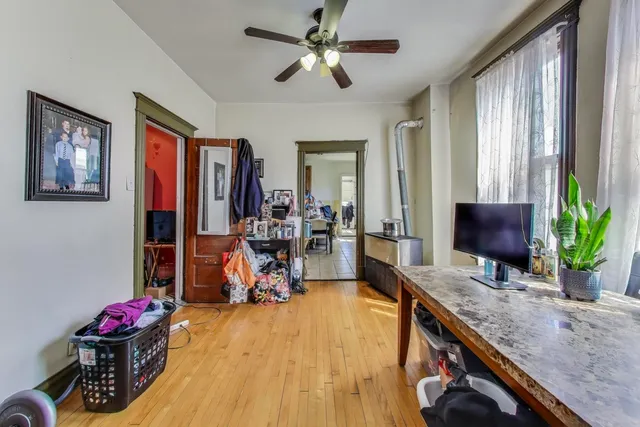 a bathroom with a shower curtain and a wooden floor