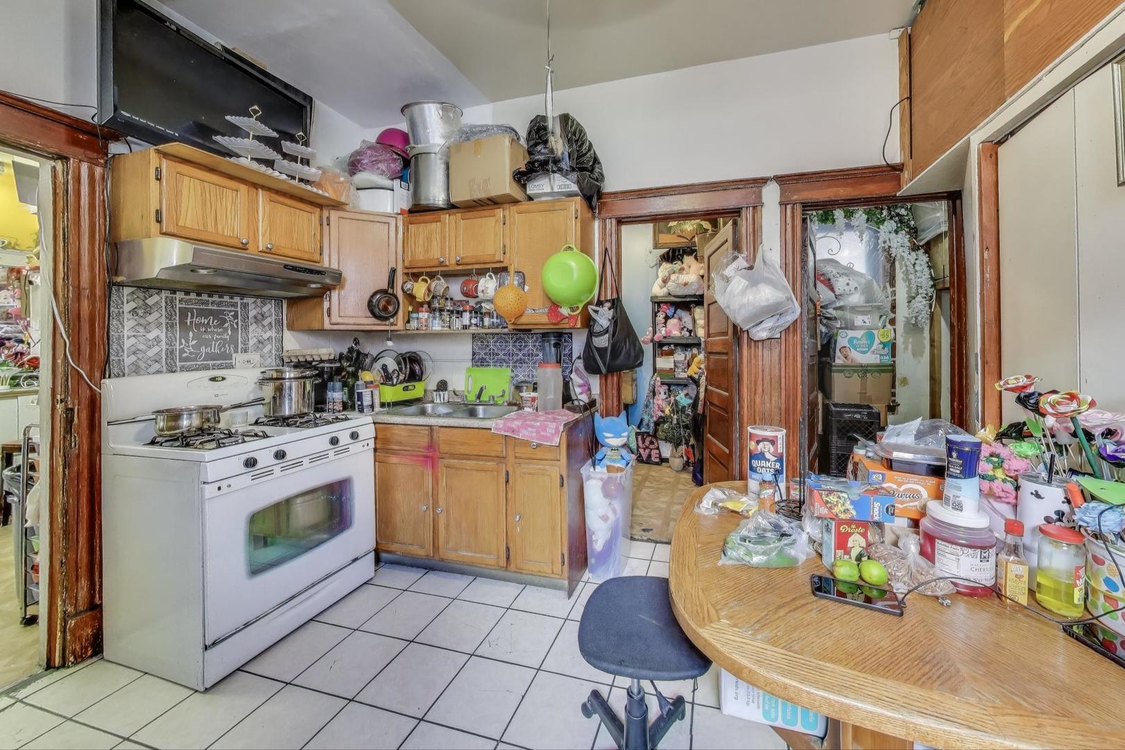 2625 South Central Park Avenue Chicago, IL 60623 - Photo 9 of 36 a kitchen with stainless steel appliances granite countertop a sink cabinets and a stove