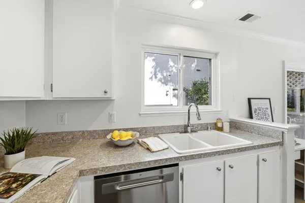 a kitchen with a table chairs sink and cabinets