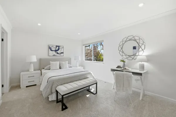 a bedroom with a bed and a couch