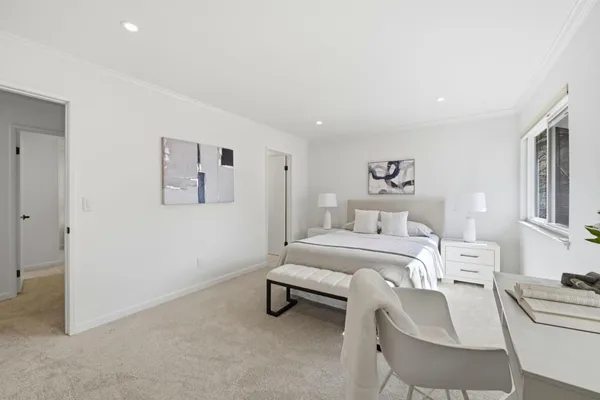 a bedroom with a bed and window