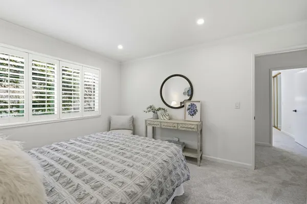 a bathroom with a granite countertop sink a toilet and a mirror