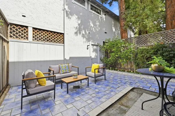 a backyard of a house with table and chairs