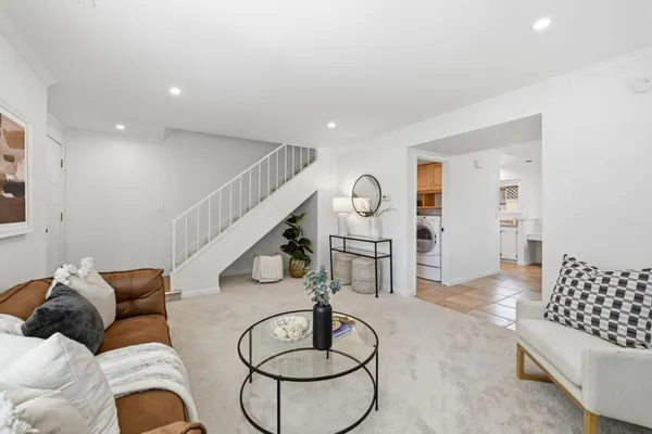 a living room with furniture and floor to ceiling window