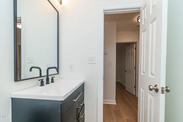 a bathroom with a sink and mirror