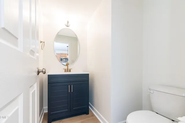a bathroom with a sink vanity mirror and toilet