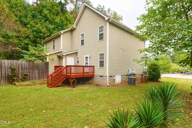 a view of a house with a yard and sitting area