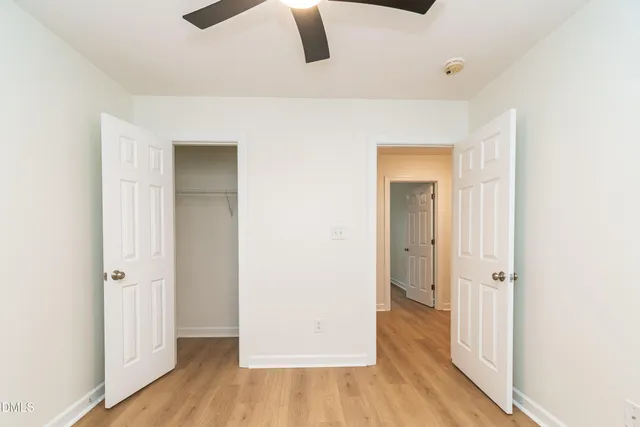 a view of a room with wooden floor