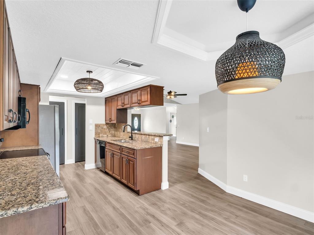 640 Kenneth Way Tarpon Springs, FL 34689 - Photo 13 of 84 a kitchen with stainless steel appliances granite countertop a sink and a stove