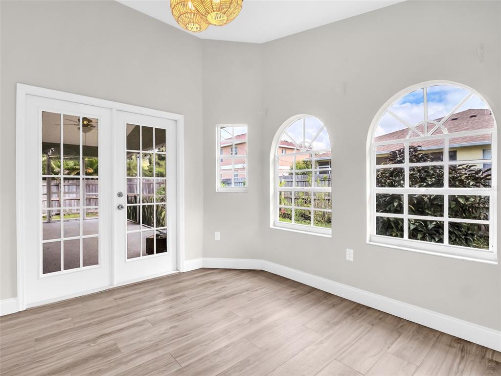 640 Kenneth Way Tarpon Springs, FL 34689 - Photo 14 of 84 an empty room with wooden floor and windows