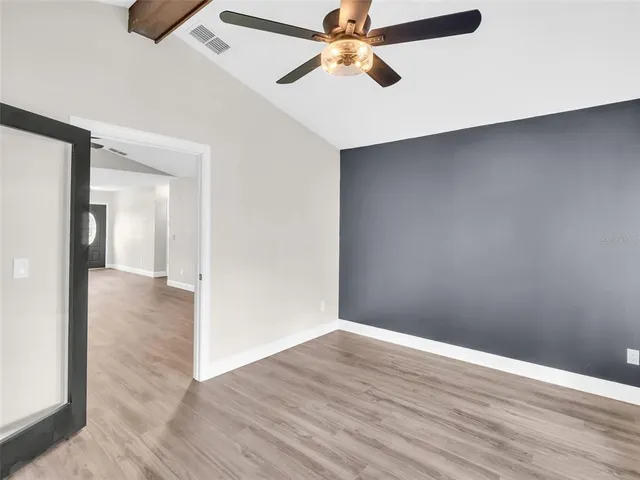 wooden floor in an empty room with a window