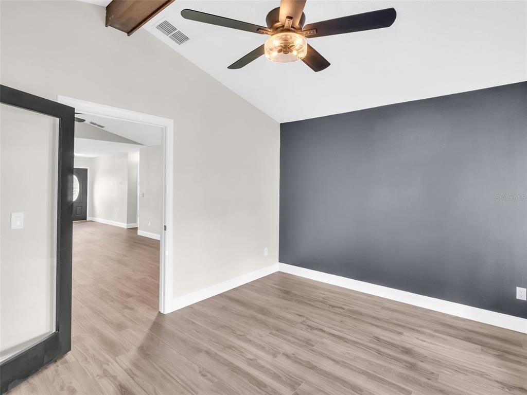 640 Kenneth Way Tarpon Springs, FL 34689 - Photo 16 of 84 wooden floor in an empty room with a window