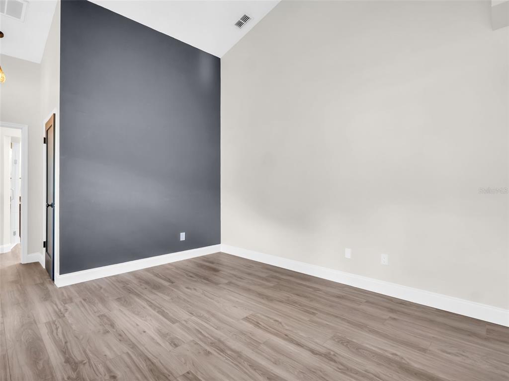 640 Kenneth Way Tarpon Springs, FL 34689 - Photo 19 of 84 a view of an empty room with wooden floor