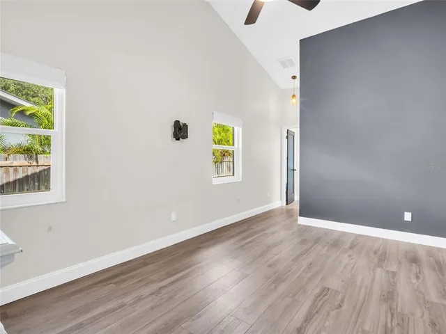 a view of a livingroom with a ceiling fan and wooden floor