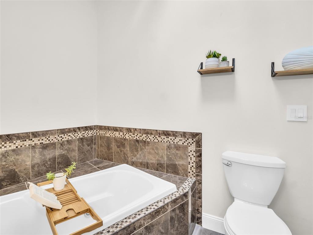 640 Kenneth Way Tarpon Springs, FL 34689 - Photo 23 of 84 a bathroom with a toilet and a sink