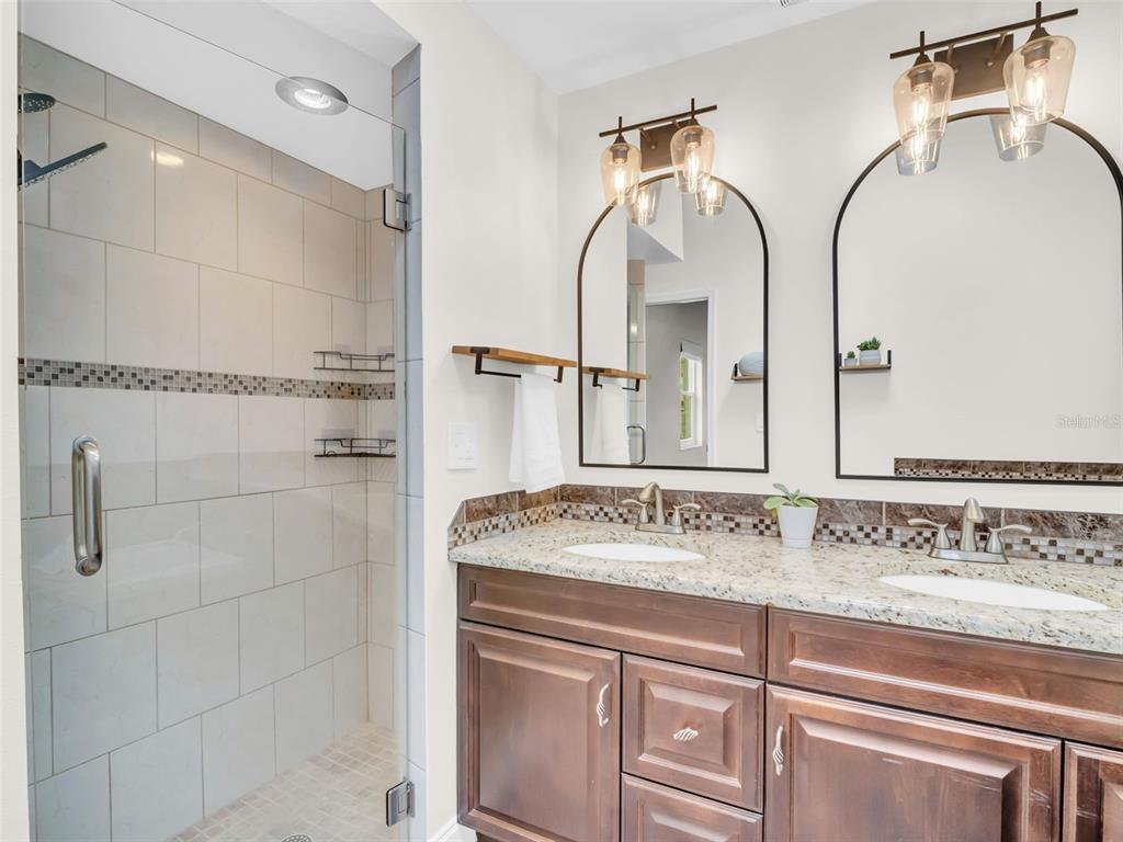 640 Kenneth Way Tarpon Springs, FL 34689 - Photo 24 of 84 a bathroom with a sink and a mirror