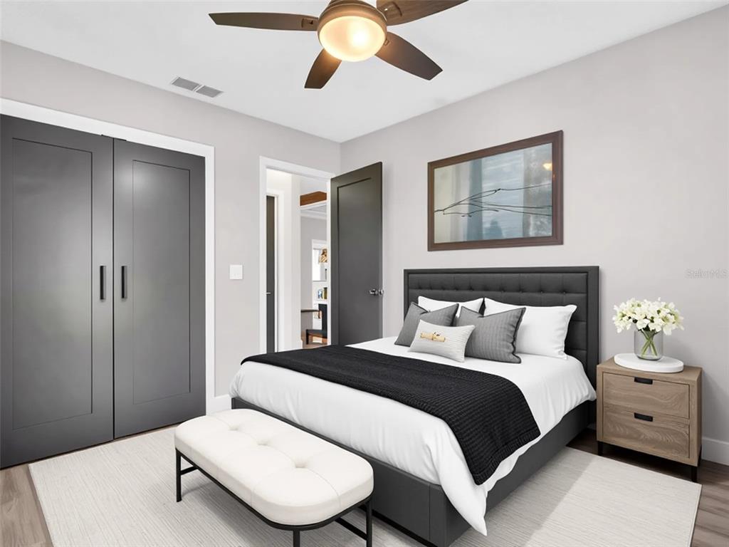 640 Kenneth Way Tarpon Springs, FL 34689 - Photo 28 of 84 a bedroom with a large bed and a chandelier