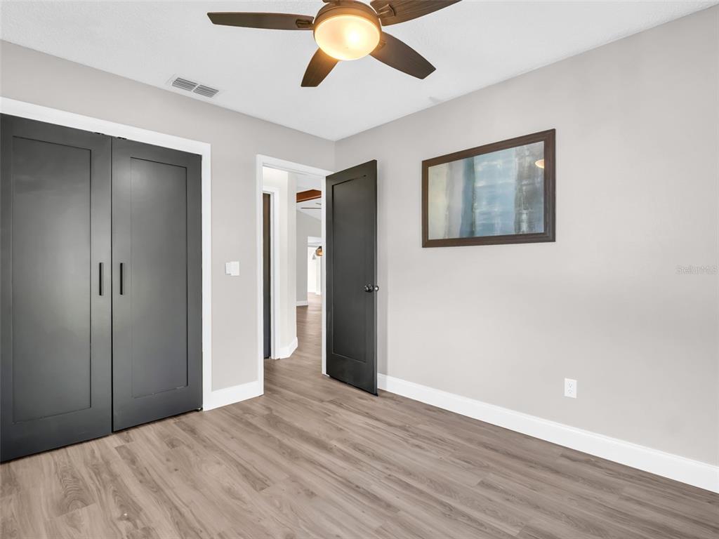 640 Kenneth Way Tarpon Springs, FL 34689 - Photo 29 of 84 a view of an empty room with wooden floor