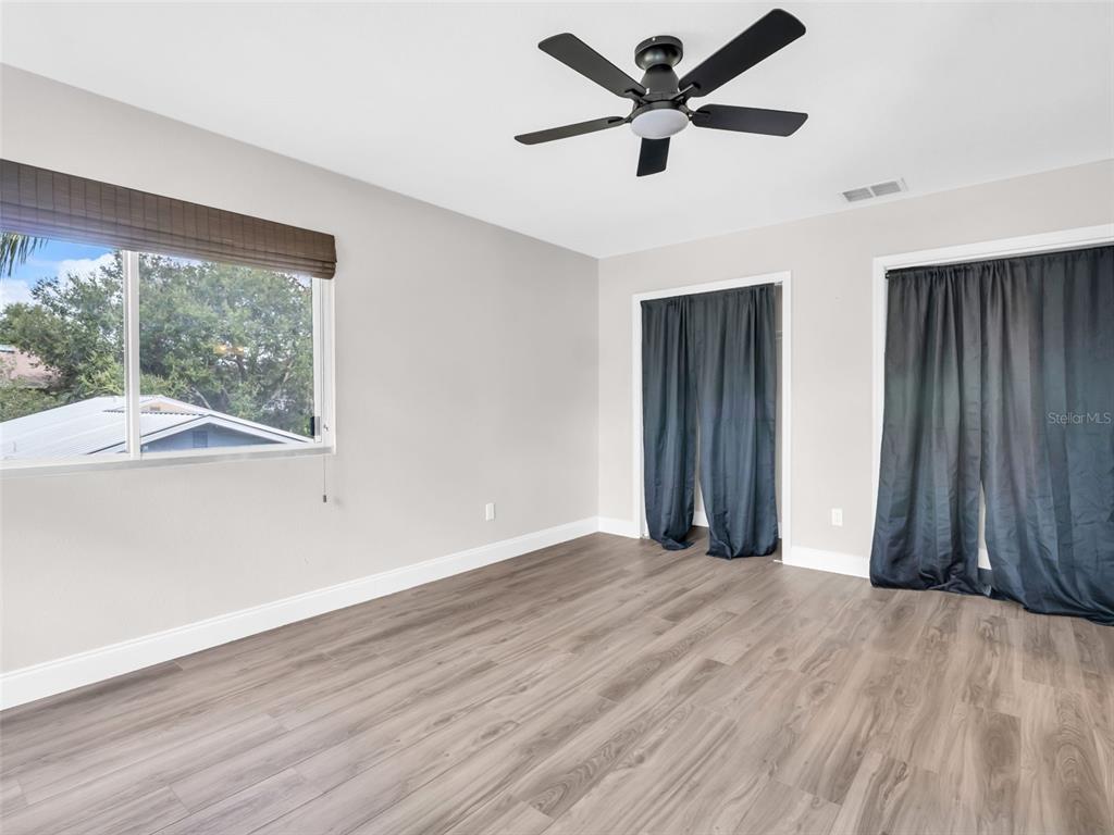 640 Kenneth Way Tarpon Springs, FL 34689 - Photo 31 of 84 a view of a livingroom with a ceiling fan and wooden floor