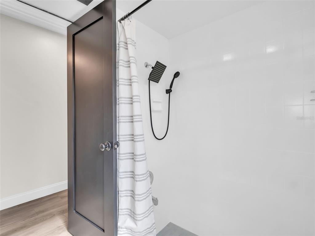 640 Kenneth Way Tarpon Springs, FL 34689 - Photo 34 of 84 a bathroom with a glass shower door