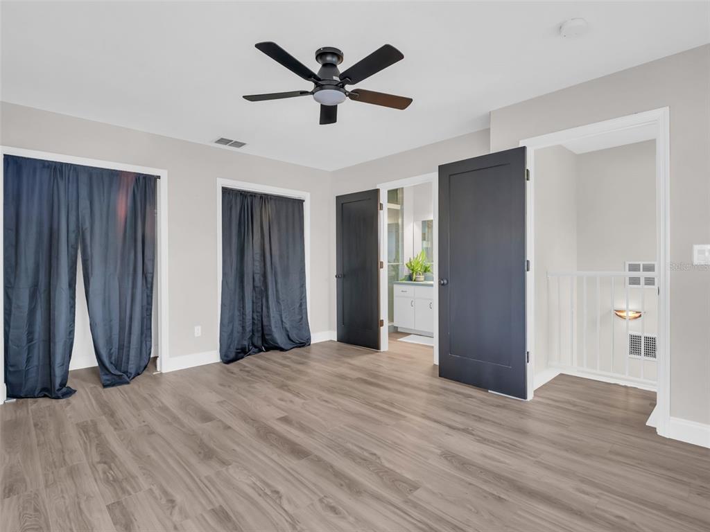 640 Kenneth Way Tarpon Springs, FL 34689 - Photo 43 of 84 a view of a livingroom with a chandelier fan and wooden floor