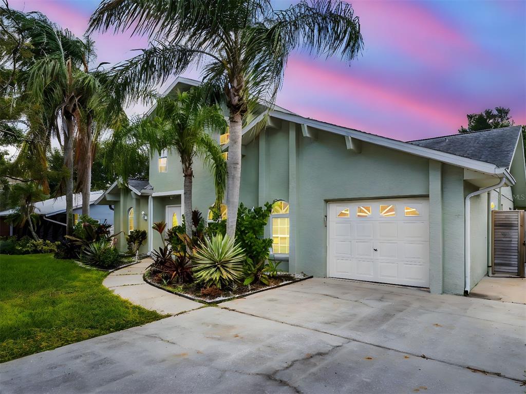 640 Kenneth Way Tarpon Springs, FL 34689 - Photo 56 of 84 a front view of a house with a yard and garage
