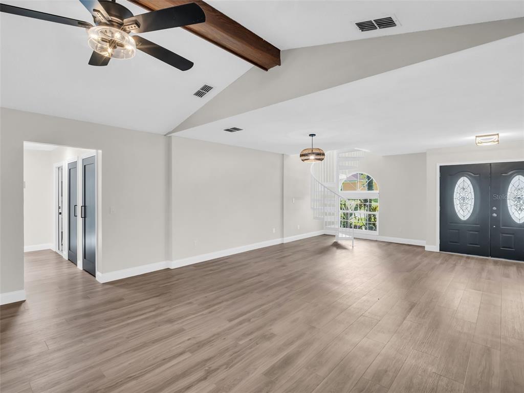 640 Kenneth Way Tarpon Springs, FL 34689 - Photo 9 of 84 a view of an empty room with a window and wooden floor