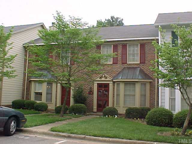 6706 Tattershale Court Raleigh, NC 27613 - Photo 1 of 1 a view of a brick house with a yard plants and a large tree
