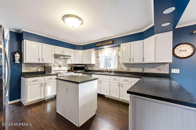 41 Hilltop Road Howell, NJ 07731 - Photo 8 of 24 a kitchen with a white cabinets and wooden floor