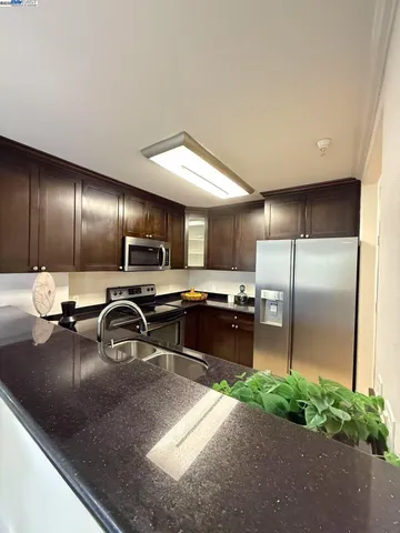 a kitchen with a refrigerator and a sink