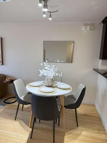 a view of a dining room with furniture and wooden floor