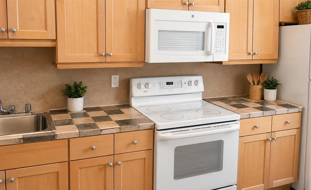 1900 Winter Park Road Winter Park, FL 32789 - Photo 13 of 22 a kitchen with cabinets appliances a sink and a window