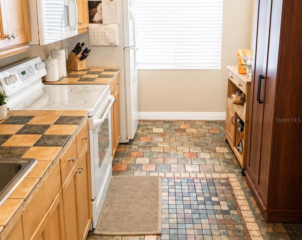 1900 Winter Park Road Winter Park, FL 32789 - Photo 14 of 22 a bathroom with a granite countertop sink and a washing machine