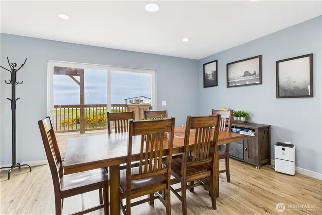 a dining room with furniture and wooden floor
