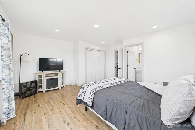 a bedroom with a bed and a flat screen tv