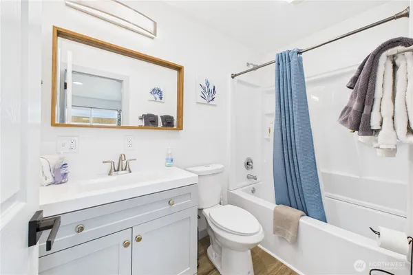a bathroom with a sink mirror vanity and toilet