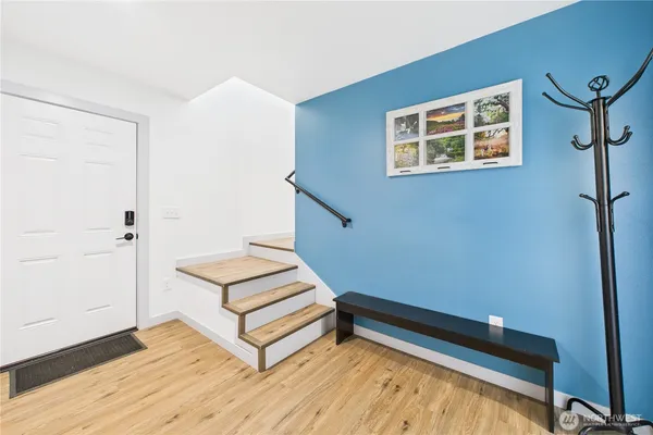 a view of a room with wooden floor and white walls