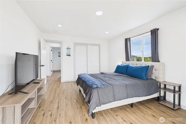 a bedroom with a bed and a flat screen tv