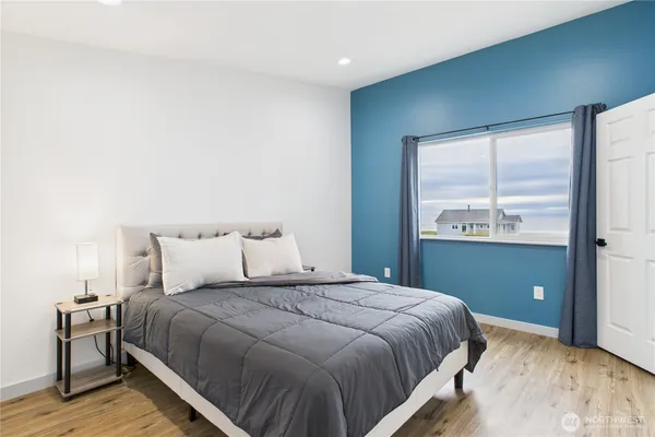 a bedroom with a bed and a window